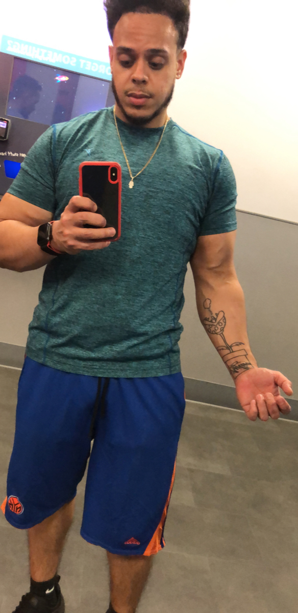 Full length shot of sweaty man with green t-shirt in mirror