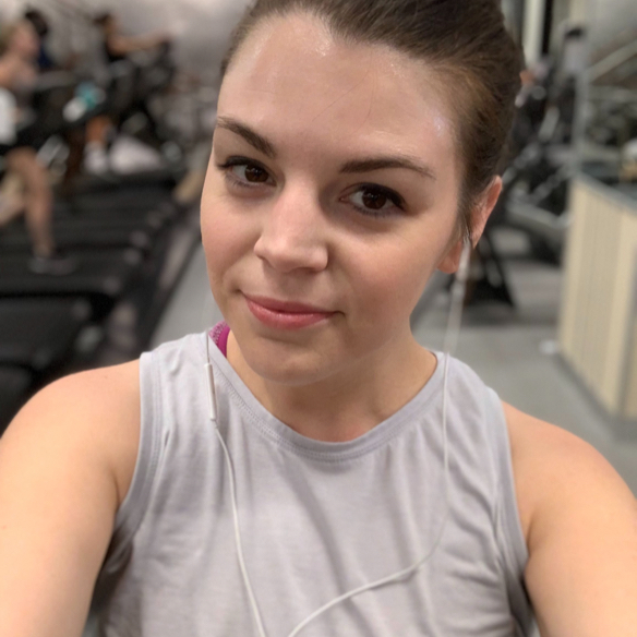 Headshot of sweaty woman with grey tank-top